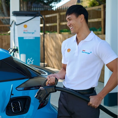 Man using phone at a Shell Recharge Station