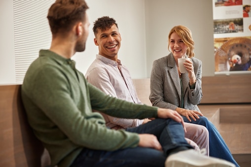 Three colleagues are in a conversation