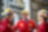 Drie medewerkers in rode overall en gele valhelm op praten met elkaar. Shell Energy and Chemicals Park Rotterdam (Pernis)