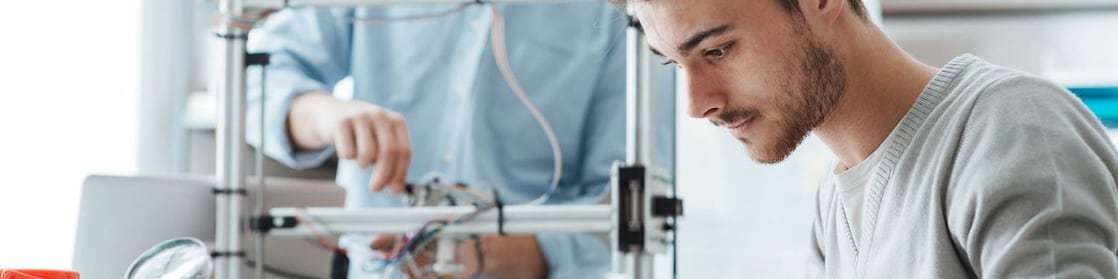 Male with beard wearing a white shirt, with a mosaic of images surrounding him.