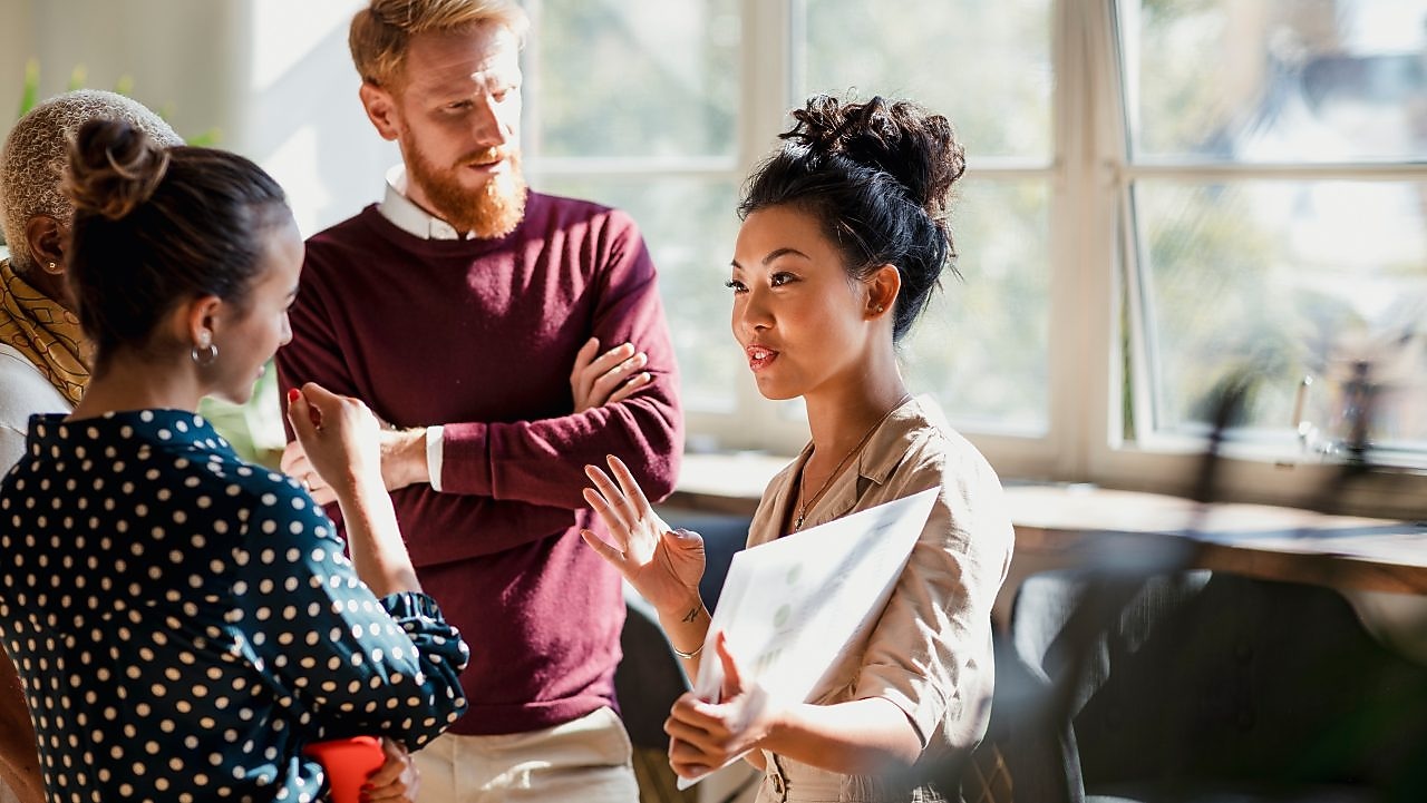 Female wearing a black hijab, with a mosaic of images surrounding her.