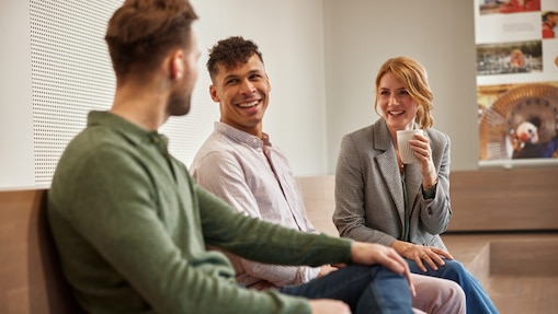 Three colleagues are in a conversation