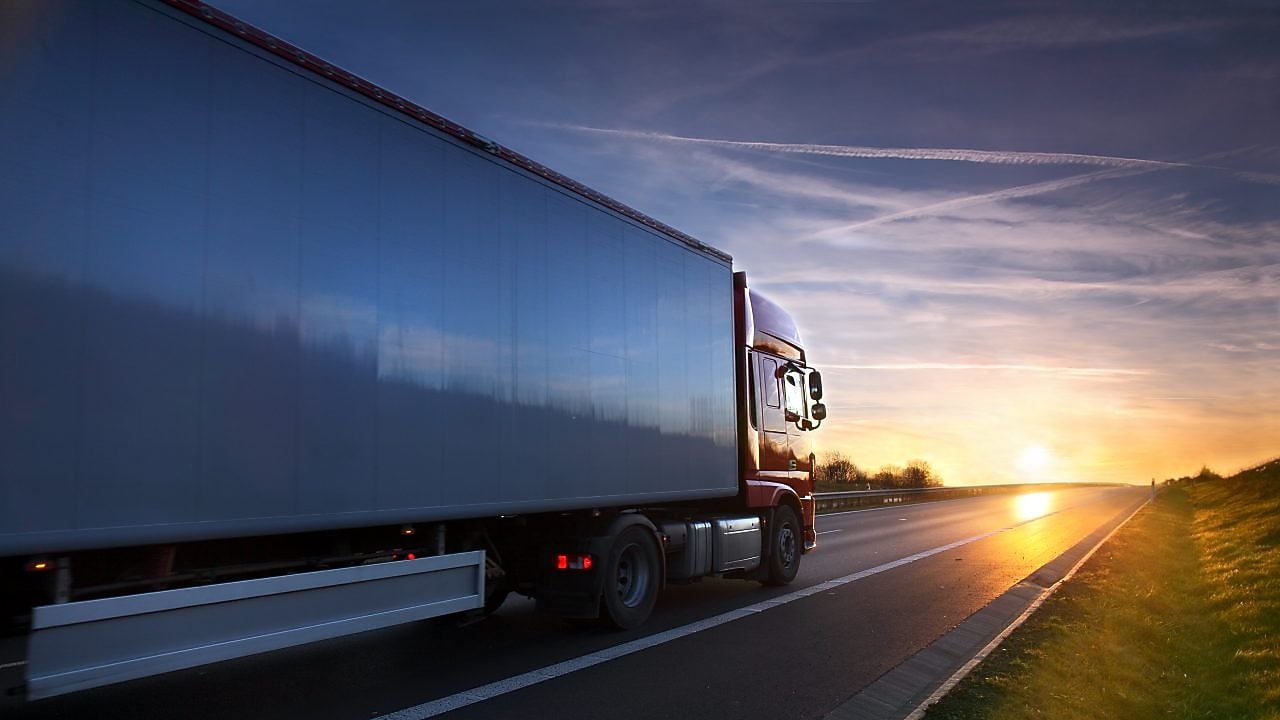 A heavy-duty truck towards the sunset