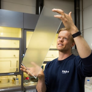 Willem Kesteloo bekijkt het resultaat van het glas met coating (Foto: Christian Kalse)