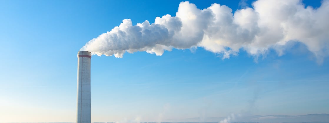 White smoke drifting away from a chimney (Photo: AI generated with Adobe Firefly)