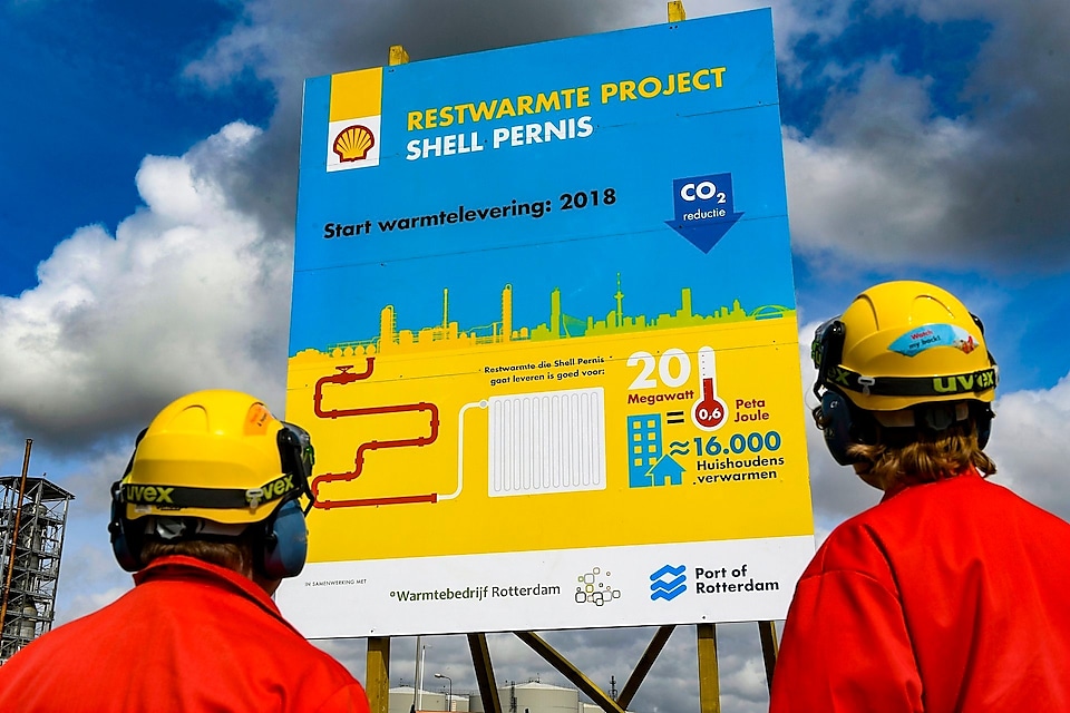 Two shell employee looking at hoardings