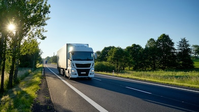 A white truck on a provincial road.