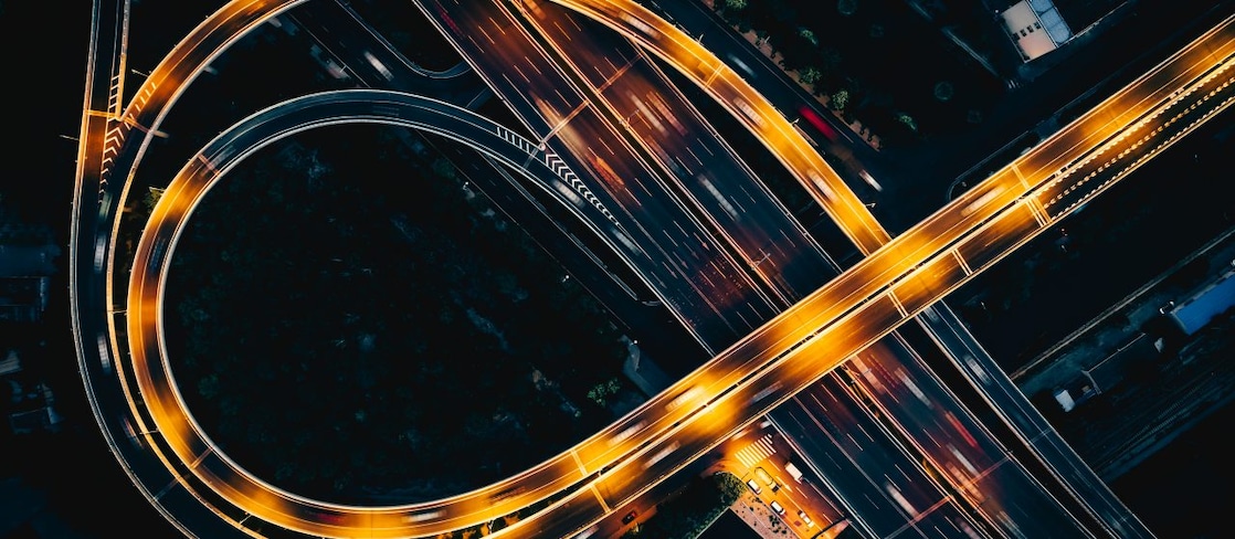 Night highway from above with light streaks