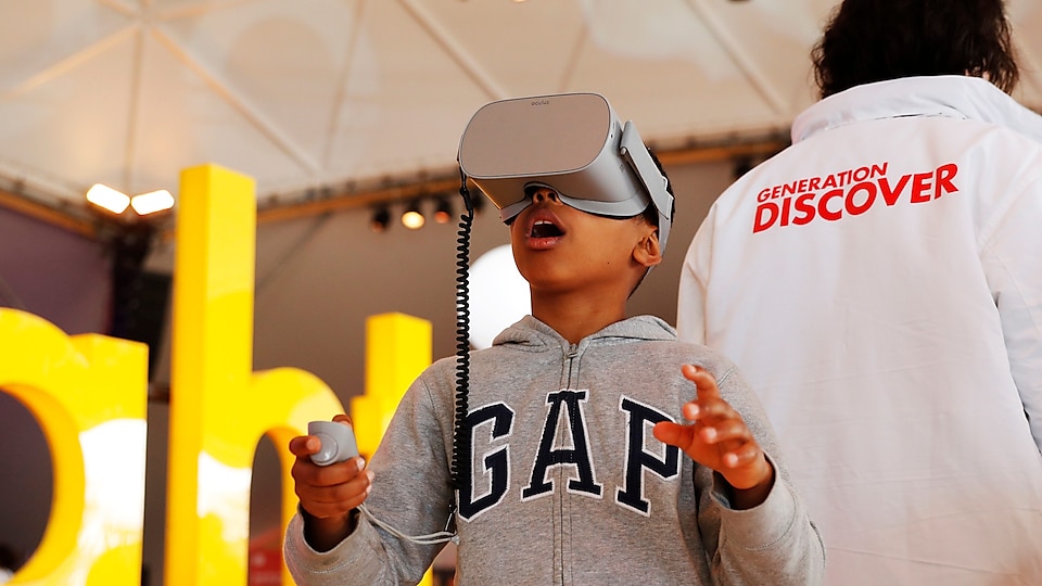 A visitor interacts with a display during Generation Discover 2018 in The Hague, Netherlands. 