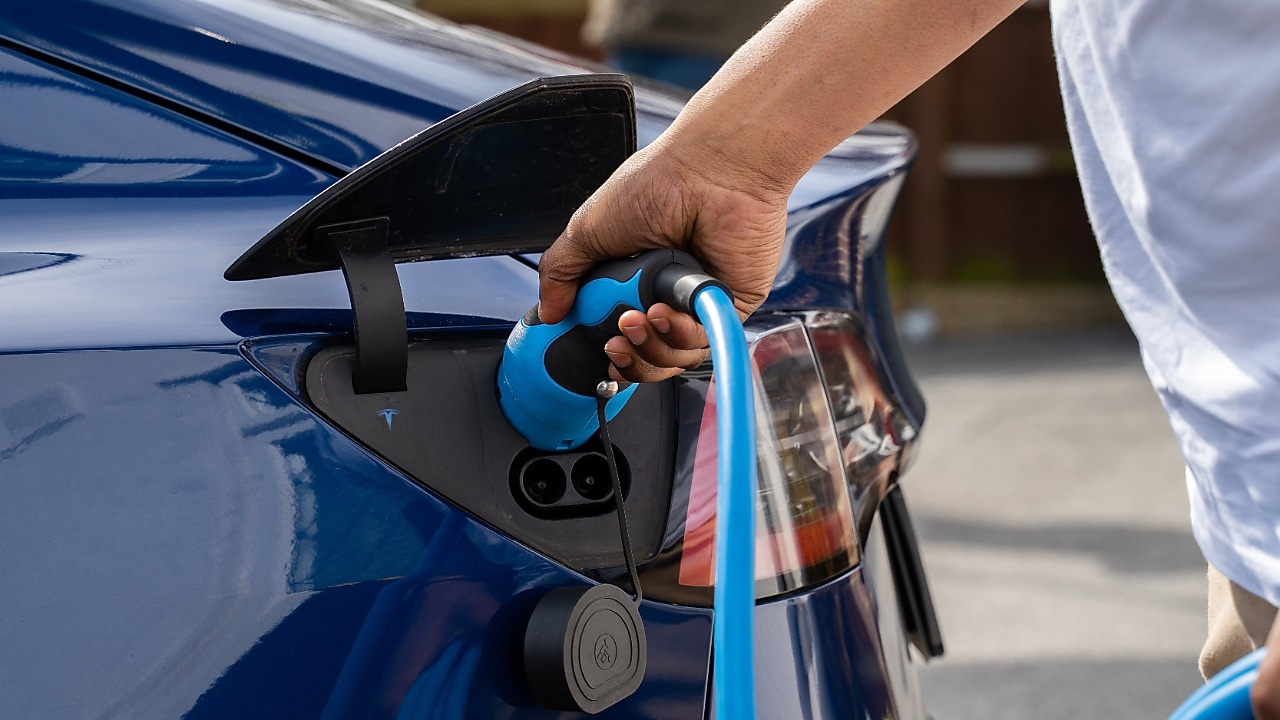 Man using phone at a Shell Recharge Station