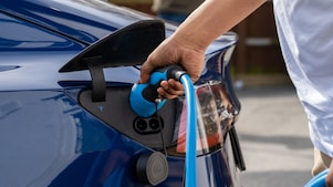 Man using phone at a Shell Recharge Station