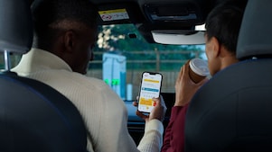 Man using phone at a Shell Recharge Station