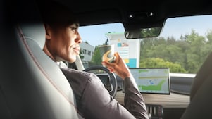 Man using phone at a Shell Recharge Station