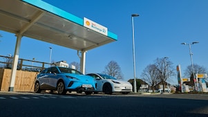 Man using phone at a Shell Recharge Station