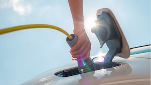 Man using phone at a Shell Recharge Station