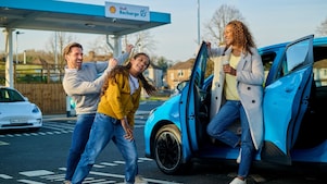 Man using phone at a Shell Recharge Station