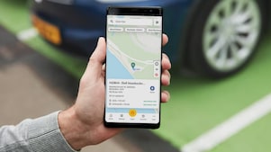 Man using phone at a Shell Recharge Station