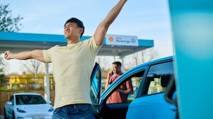 Man using phone at a Shell Recharge Station