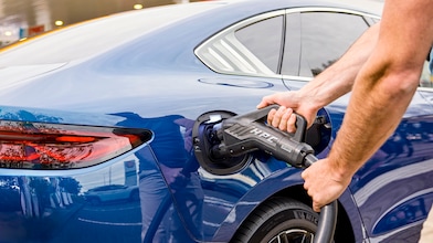 Man using phone at a Shell Recharge Station