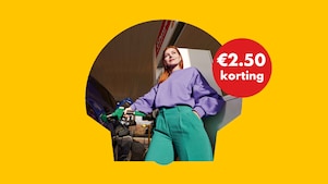 A bright yellow car covered in soap foam passes through an automated car‑wash machine with large black‑and‑white rotating brushes, set against a green background with small red and white graphic plus symbols.