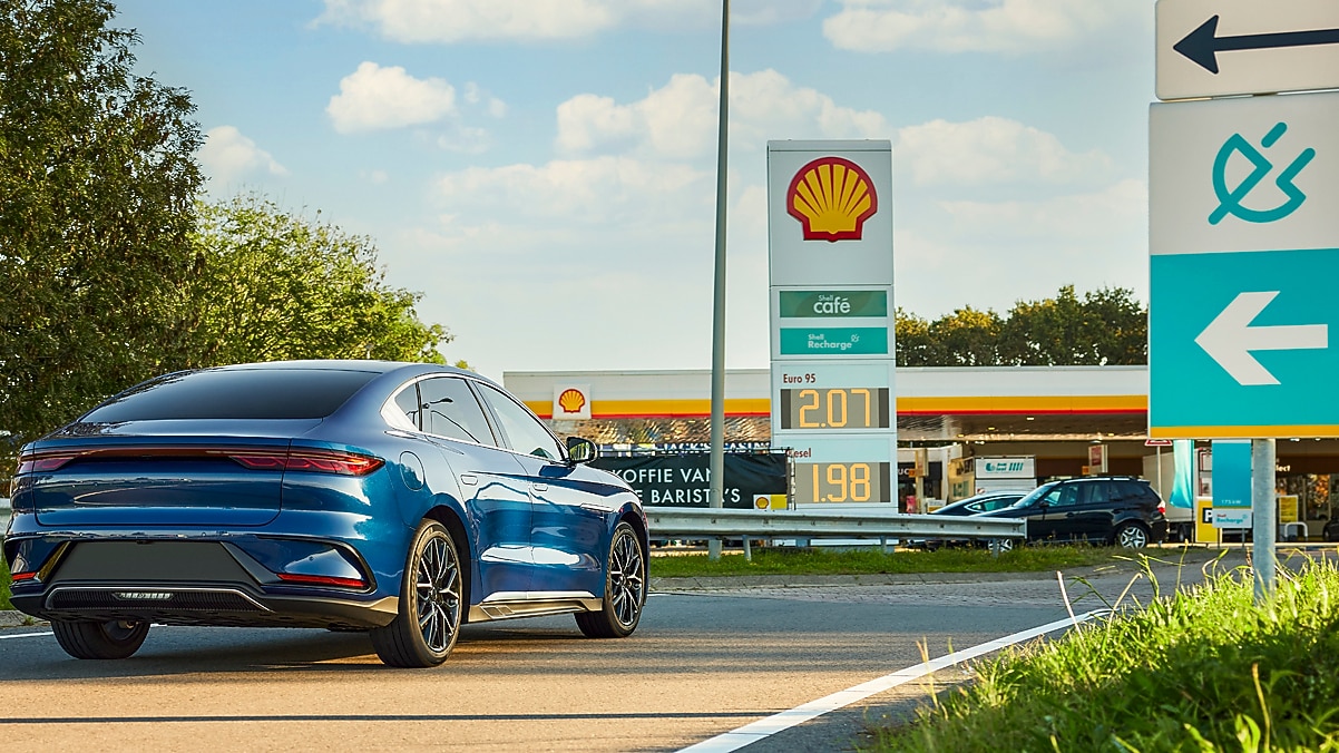 Man using phone at a Shell Recharge Station