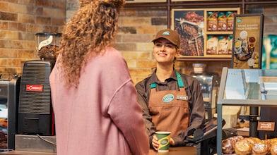 Man using phone at a Shell Recharge Station