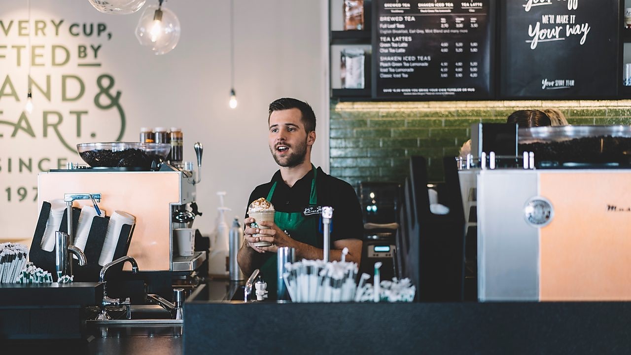 man behind the counter at starbucks