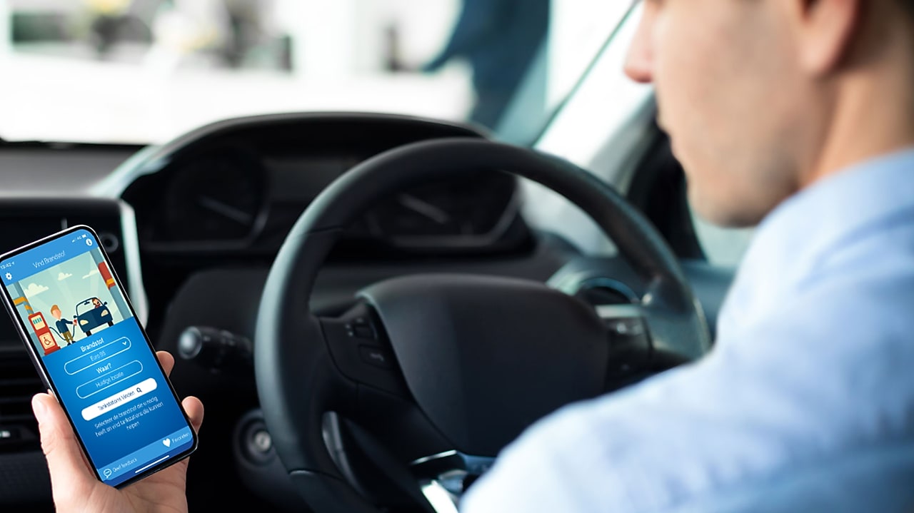 Man using phone at a Shell Recharge Station