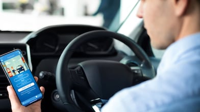 Man using phone at a Shell Recharge Station