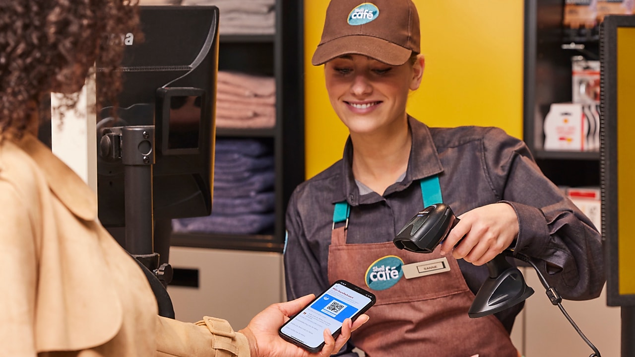 Man using phone at a Shell Recharge Station