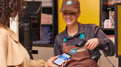 Man using phone at a Shell Recharge Station
