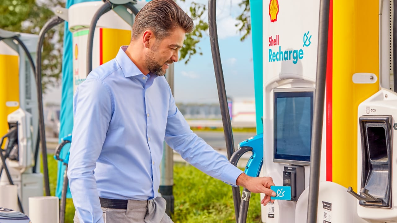 Man using phone at a Shell Recharge Station