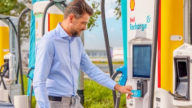 Man using phone at a Shell Recharge Station